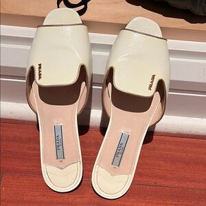 Prada Women's Cream Mules with Gold Accents